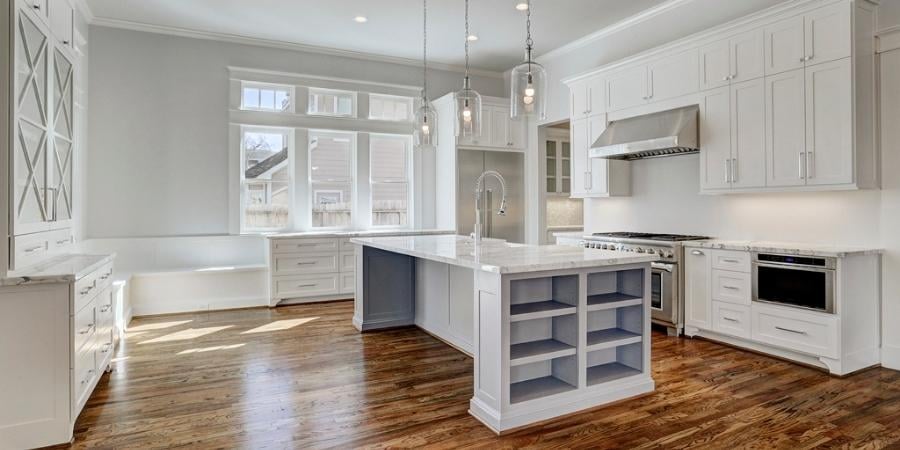 Beautiful Kitchen Featuring White Accents and Wood Flooring