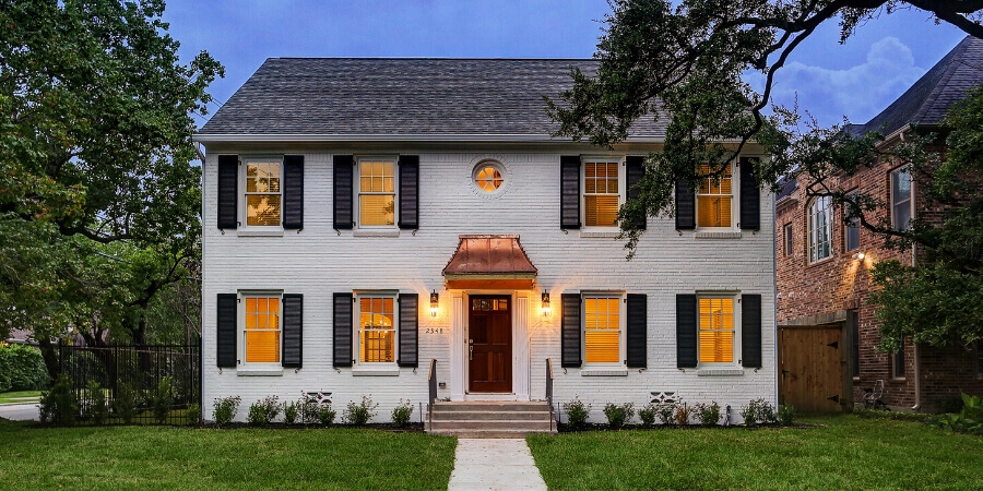 Front exterior of white transitional custom home in Houston, TX by Southern Green Builders